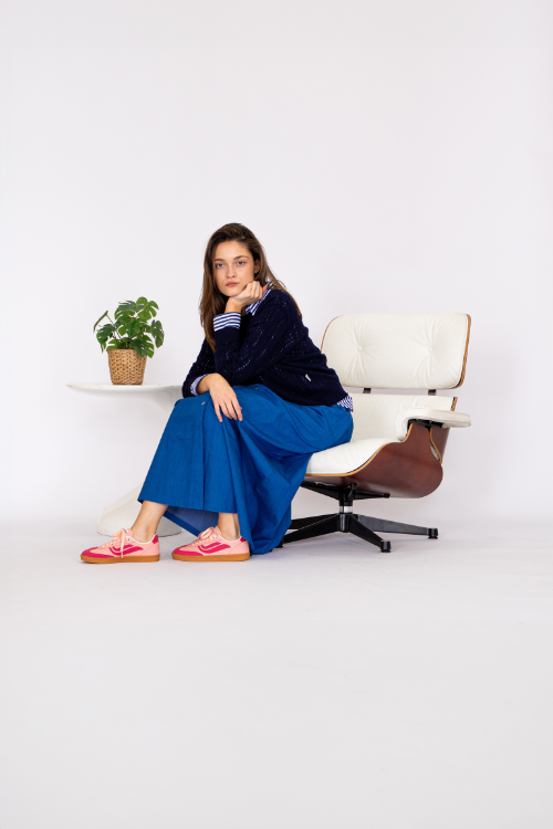 Zu einer Pyramide aufgetürmte Veja Fair Trade Sneaker vor beigem Hintergrund