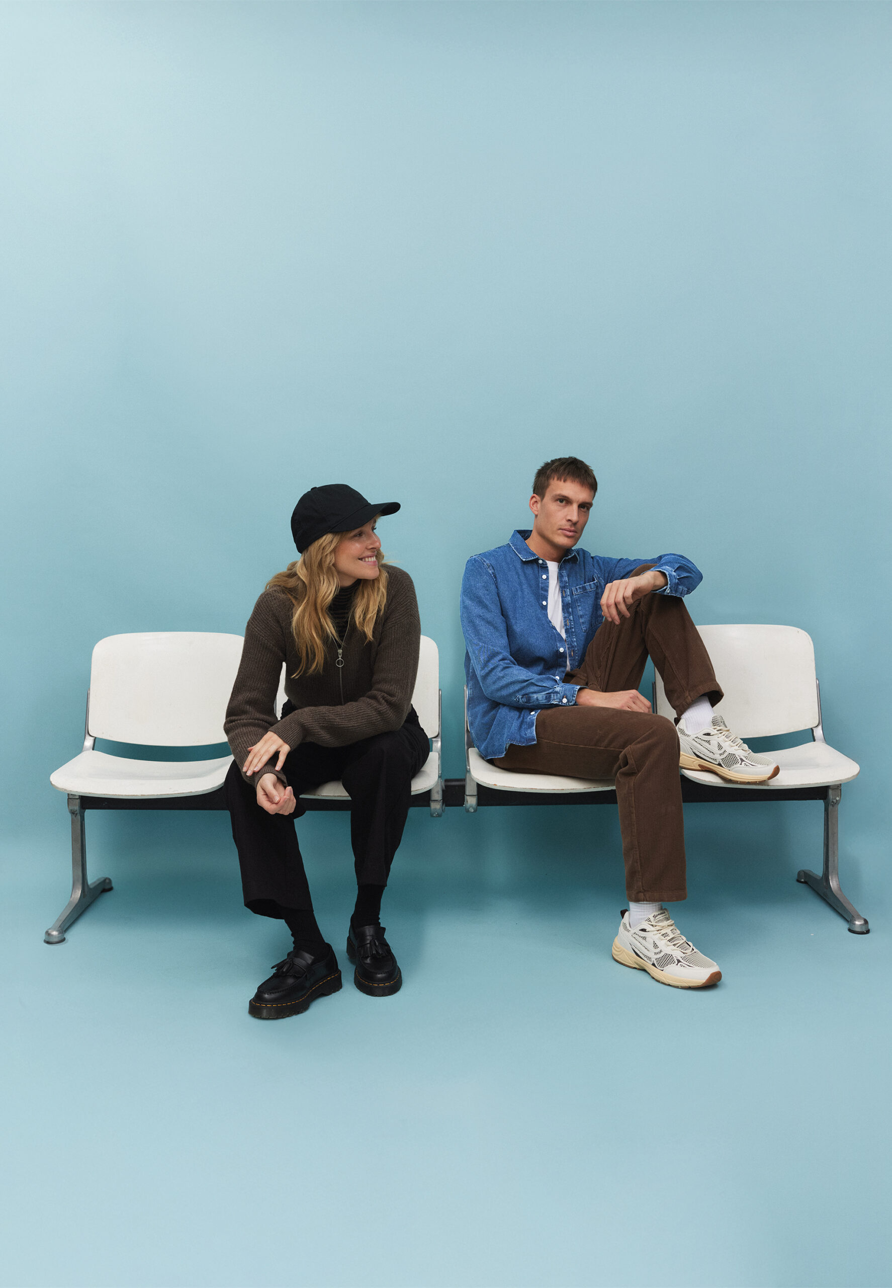 Image Couple zündstoff Mann und Frau in Outfits von Recolution sitzen auf einer Bank